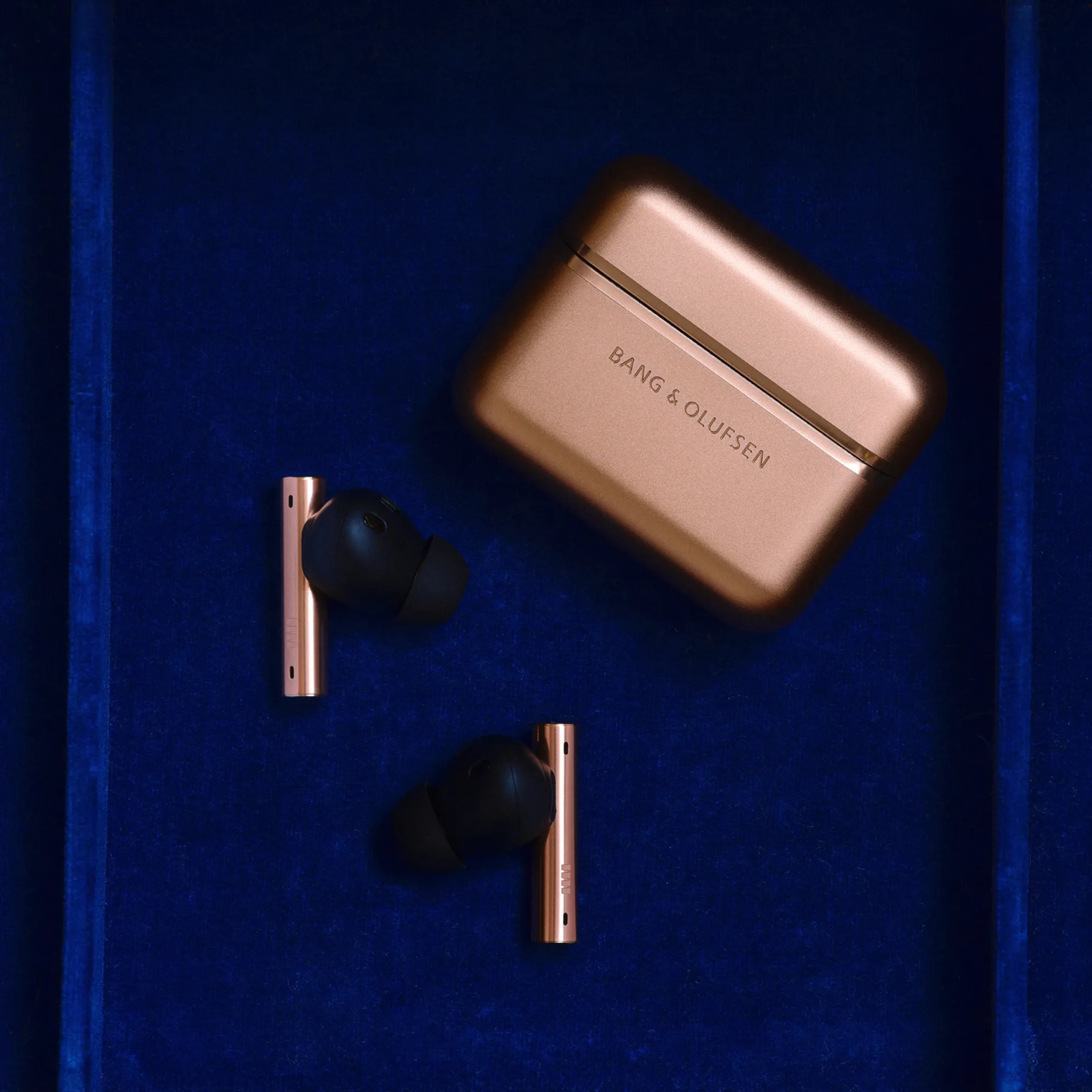 Pair of Beo Grace honey tone and case with blue background
